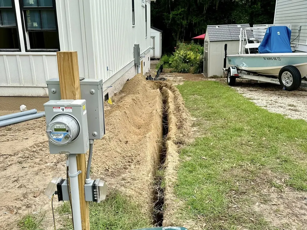 Fresh utility trench running beside a residential building